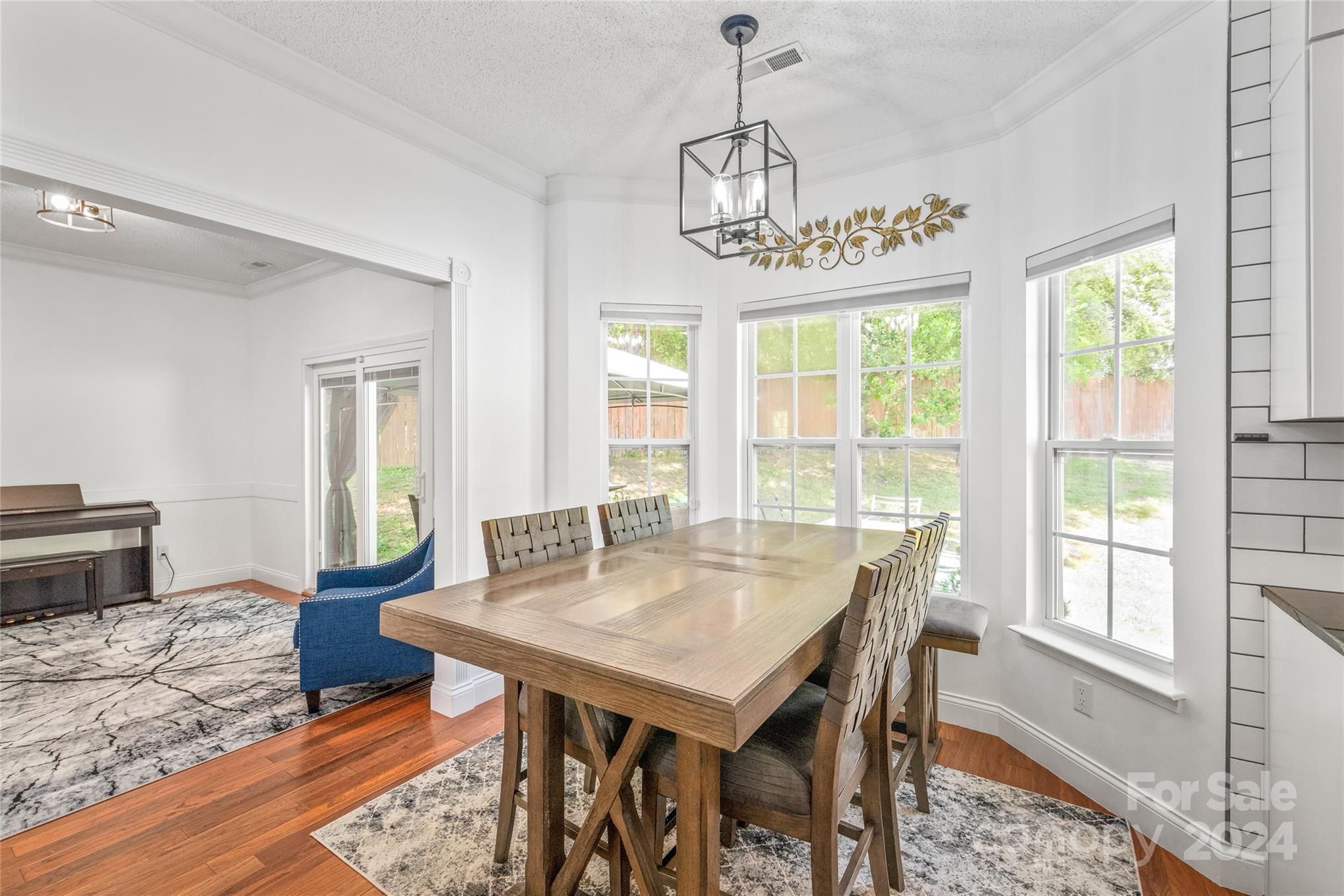 3008 Viola Lane Monroe, NC 28110 - Photo 15 of 36 a view of a dining room with furniture window and wooden floor
