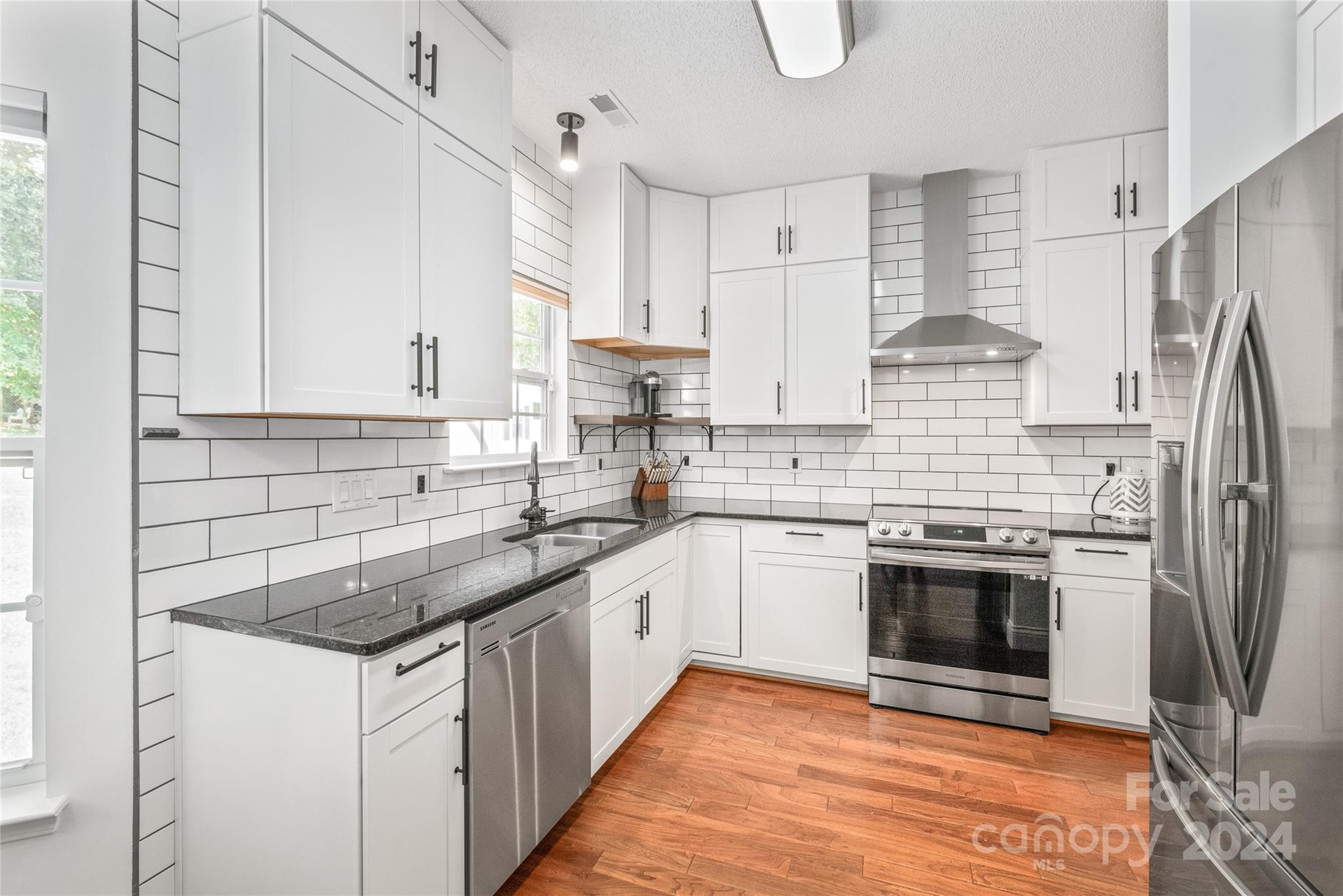 3008 Viola Lane Monroe, NC 28110 - Photo 16 of 36 a kitchen with stainless steel appliances granite countertop a sink stove and refrigerator