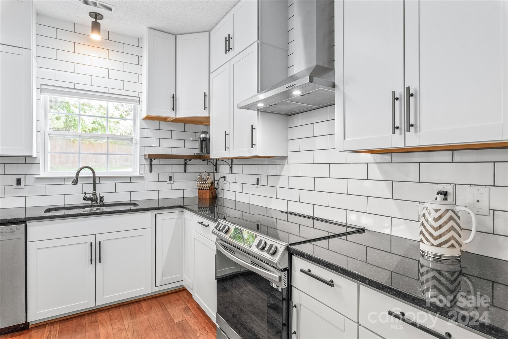 3008 Viola Lane Monroe, NC 28110 - Photo 18 of 36 a kitchen with stainless steel appliances granite countertop a sink a stove and cabinets