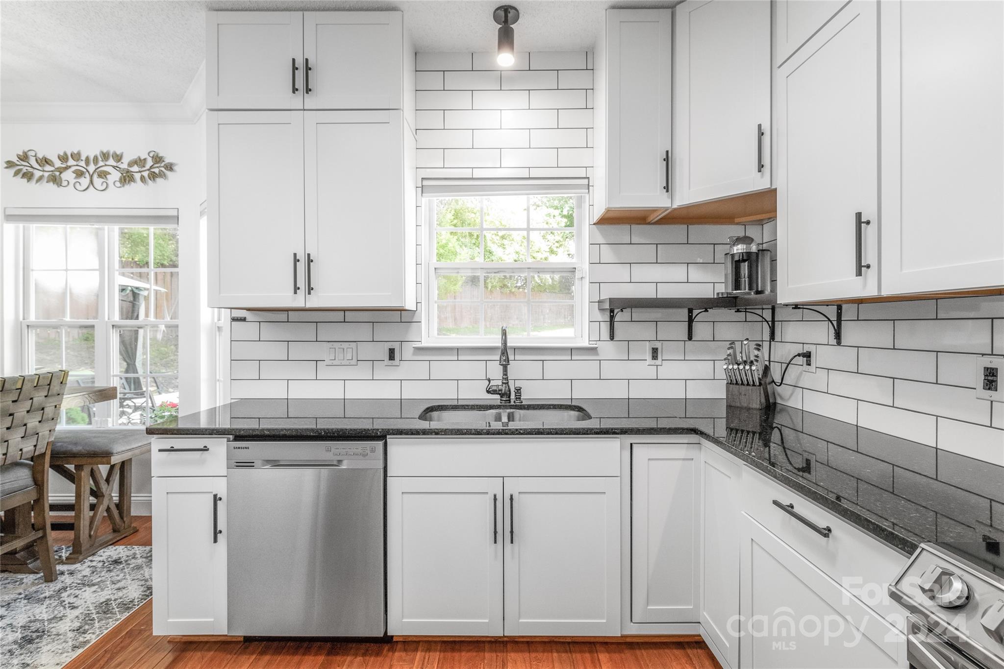 3008 Viola Lane Monroe, NC 28110 - Photo 19 of 36 a kitchen with cabinets appliances a sink and a window