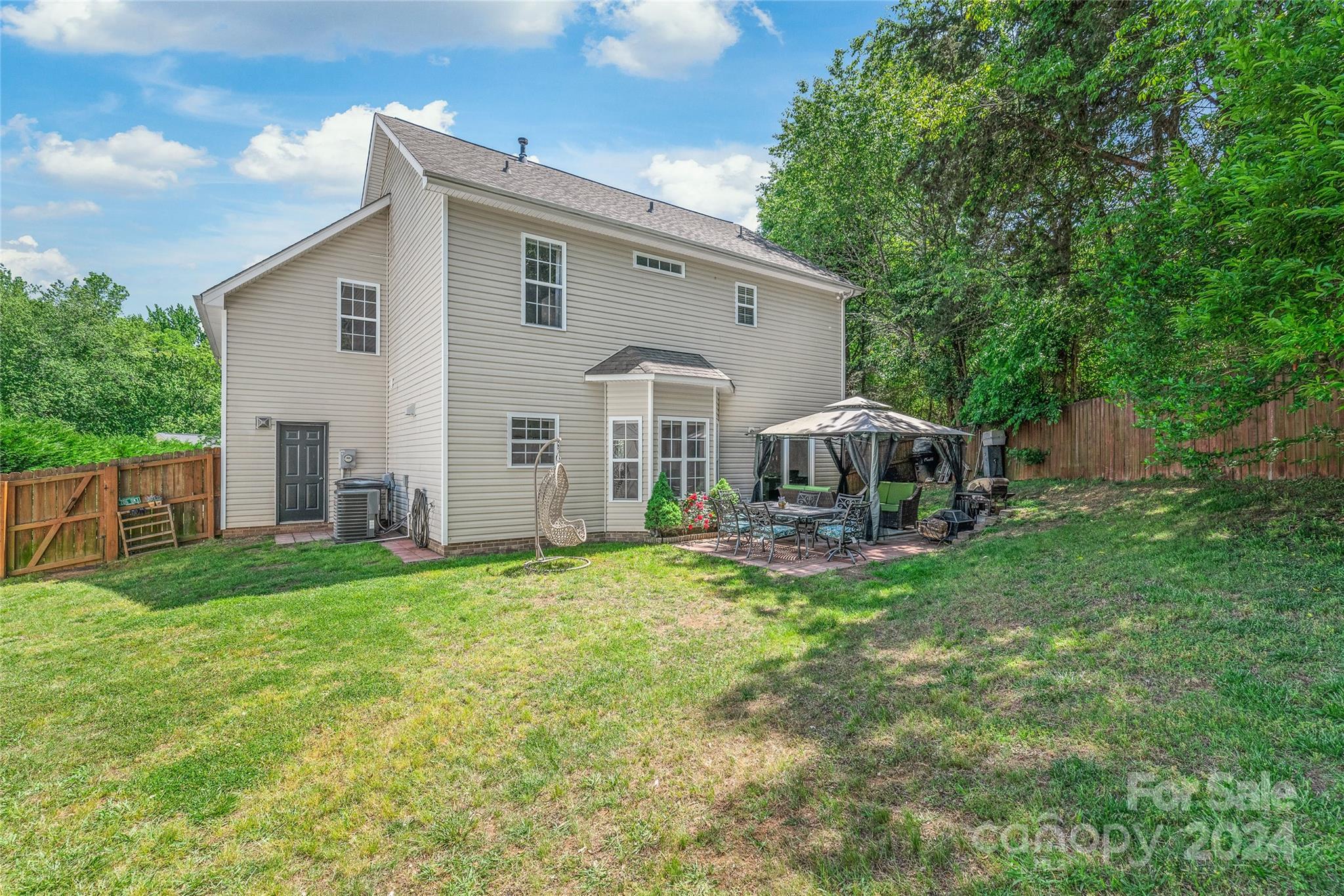 3008 Viola Lane Monroe, NC 28110 - Photo 32 of 36 a view of a house with backyard sitting area and garden