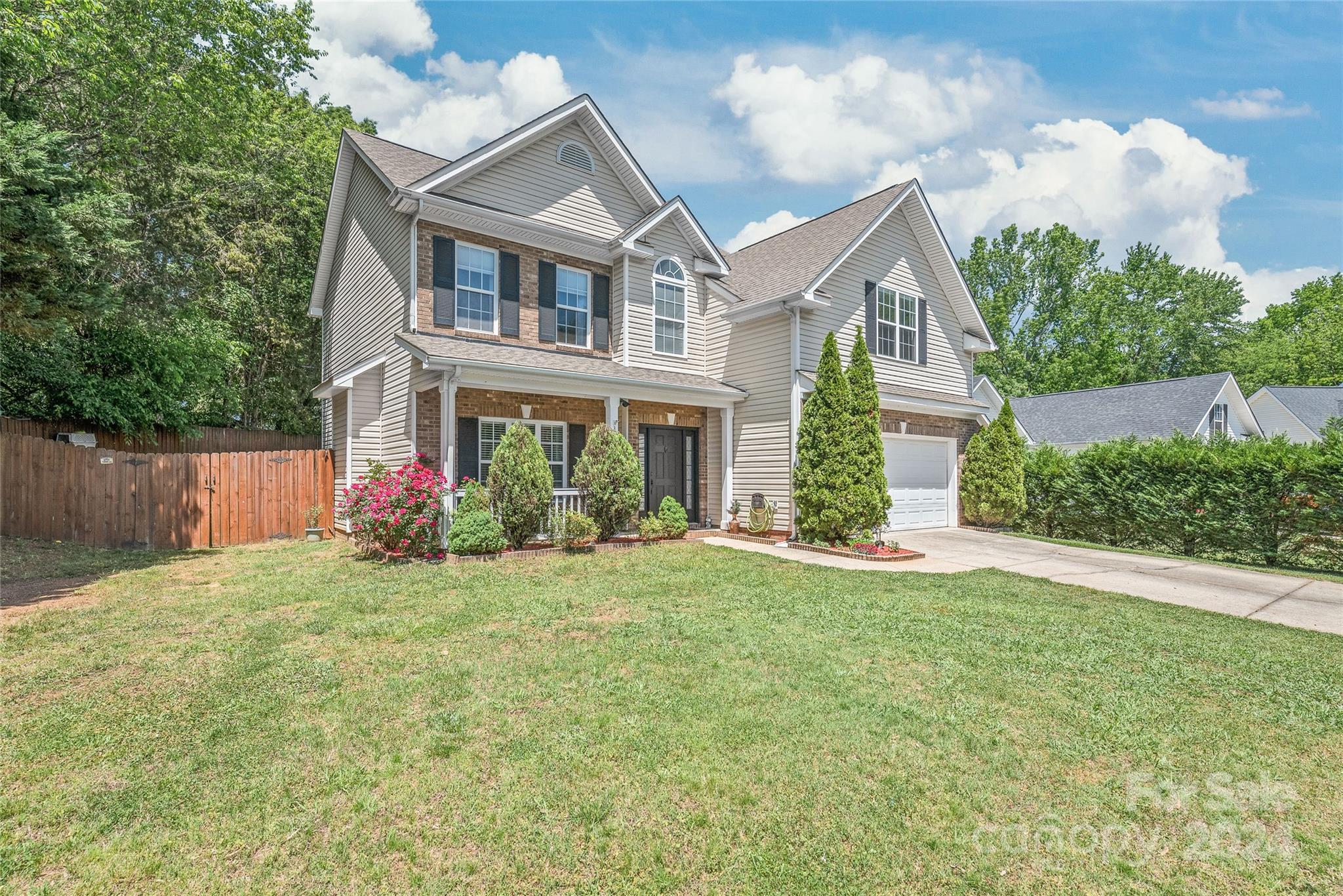 3008 Viola Lane Monroe, NC 28110 - Photo 4 of 36 a front view of a house with a yard and garage