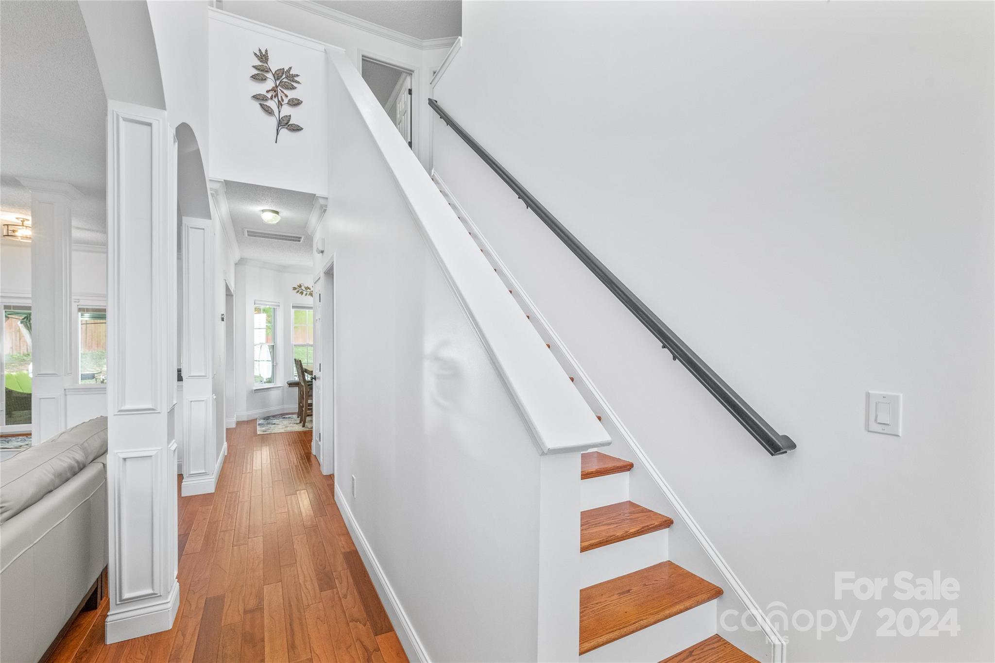 3008 Viola Lane Monroe, NC 28110 - Photo 7 of 36 a view of a hallway with wooden floor and staircase
