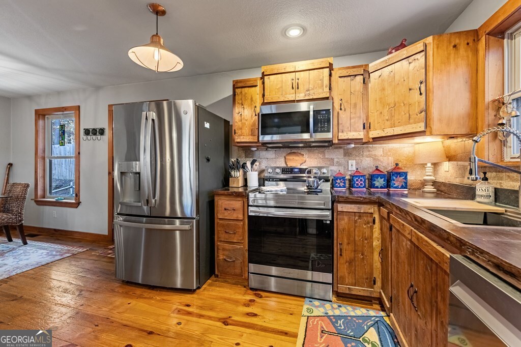 90 Hay Lane Morganton, GA 30560 - Photo 10 of 77 a kitchen with stainless steel appliances granite countertop a refrigerator a stove a sink and a microwave