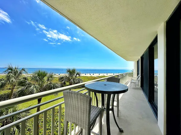 a view of a balcony with a table and chairs