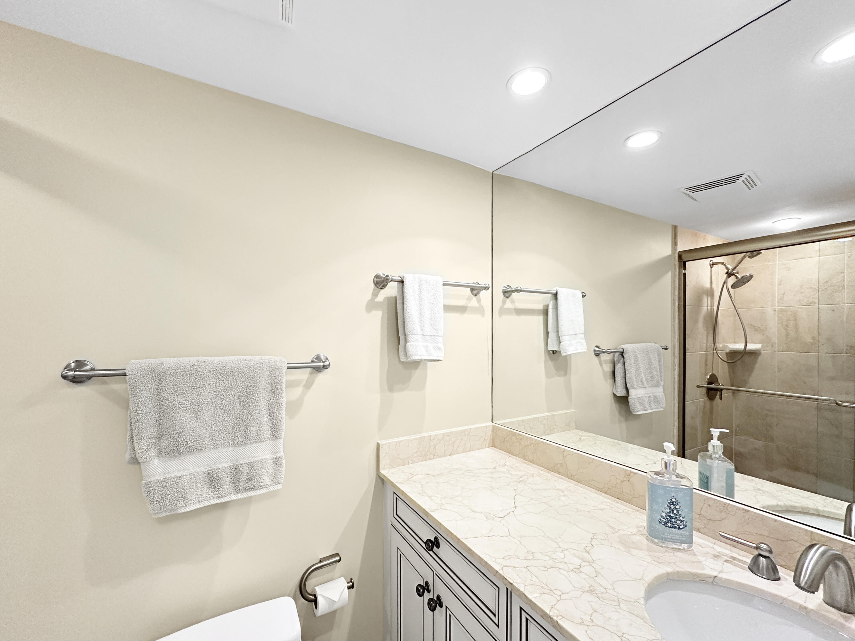 3000 North Ocean Drive, Unit 4F Riviera Beach, FL 33404 - Photo 14 of 56 a bathroom with a granite countertop sink a mirror and a shower