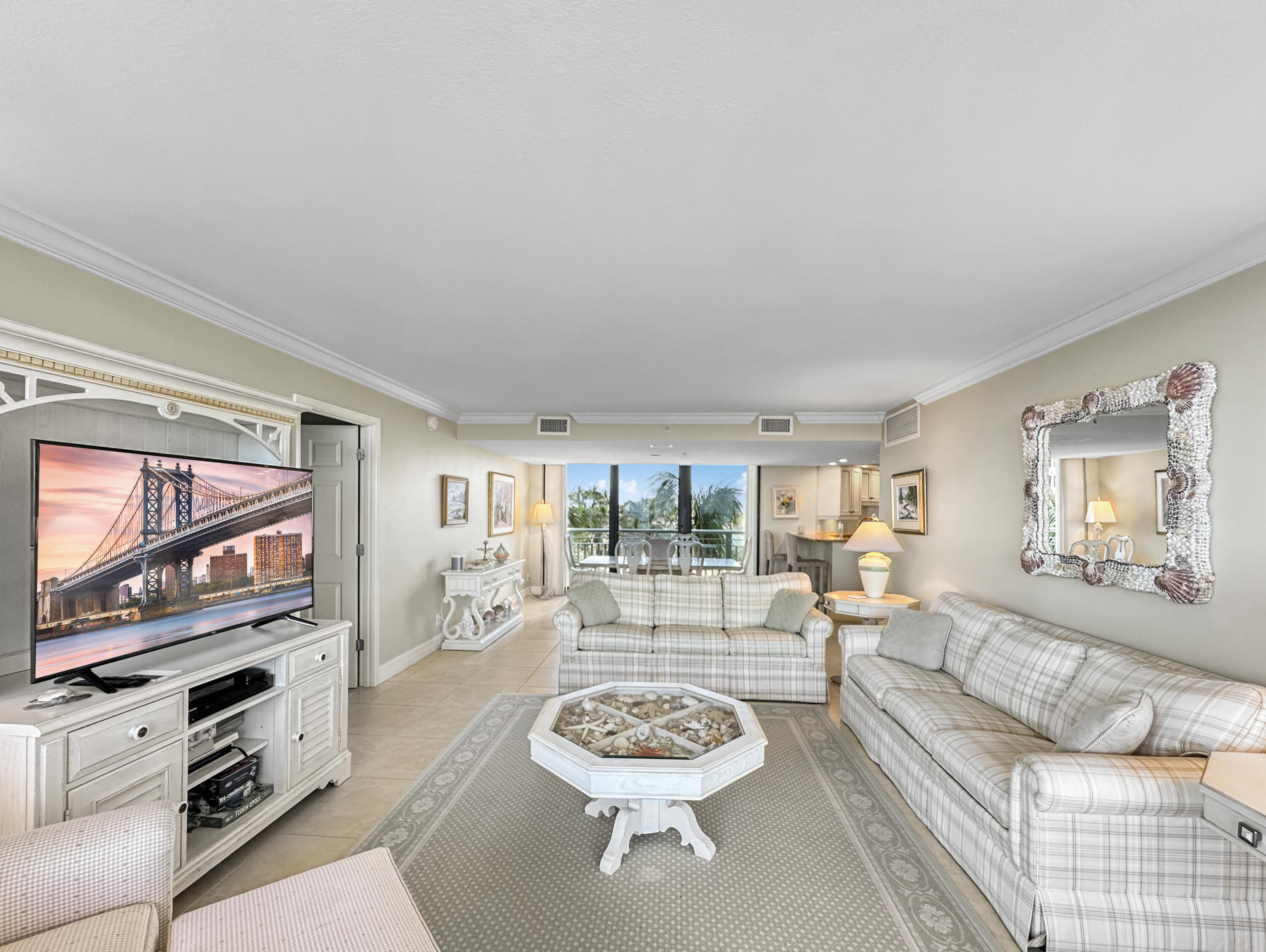 3000 North Ocean Drive, Unit 4F Riviera Beach, FL 33404 - Photo 5 of 56 a living room with furniture and a flat screen tv