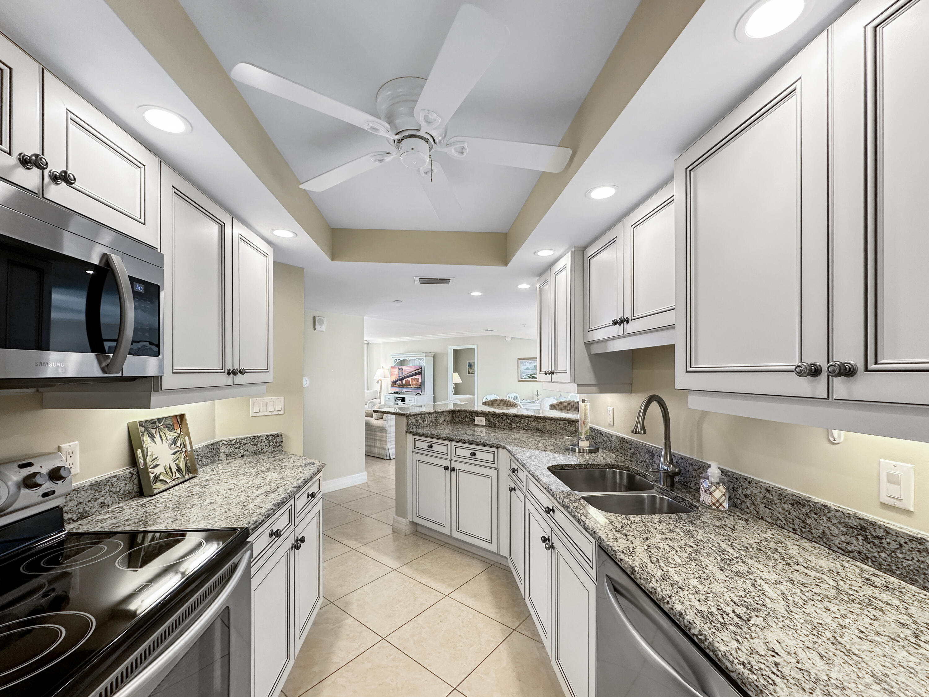 3000 North Ocean Drive, Unit 4F Riviera Beach, FL 33404 - Photo 8 of 56 a kitchen with stainless steel appliances granite countertop a sink stove and cabinets