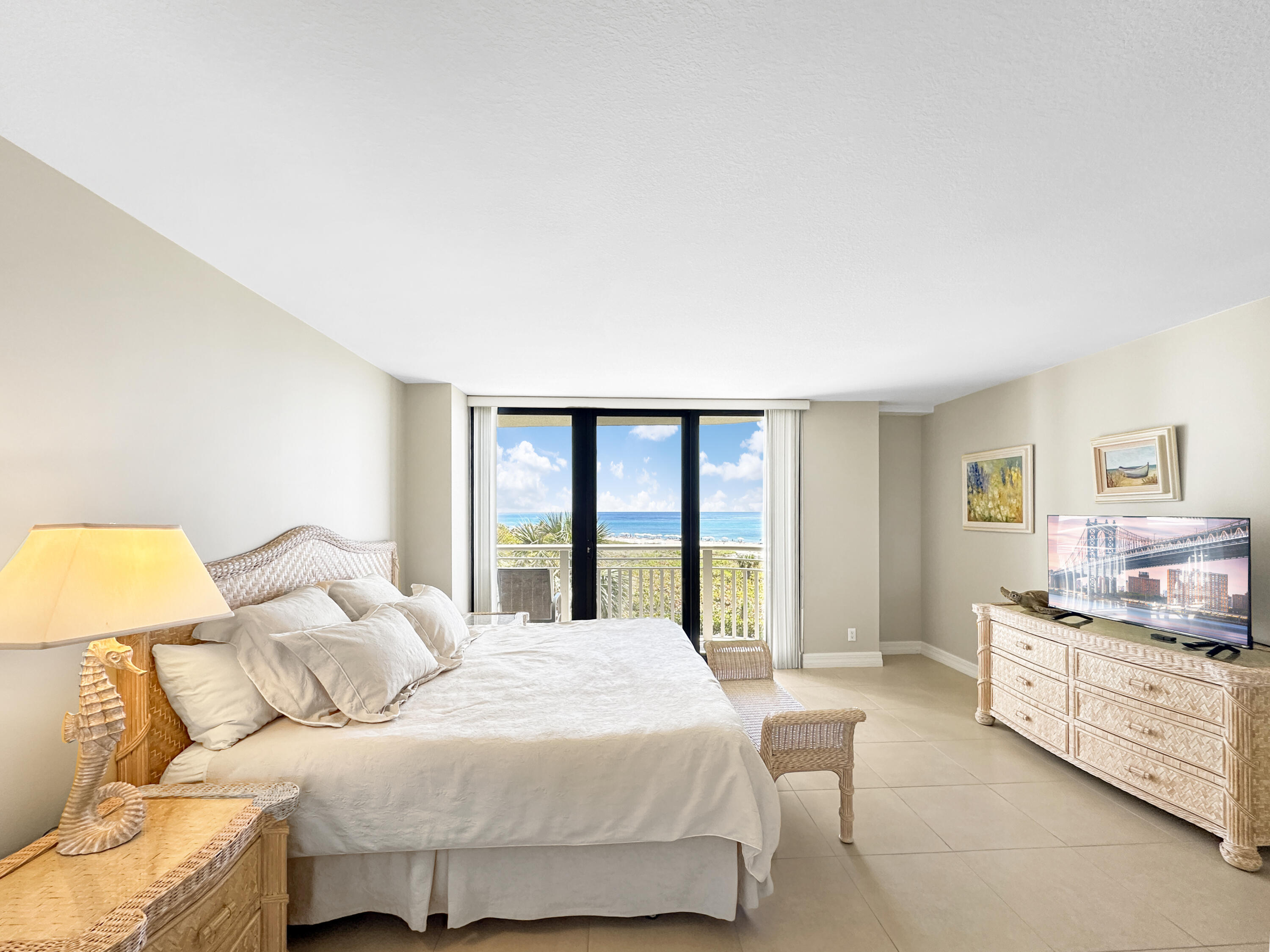 3000 North Ocean Drive, Unit 4F Riviera Beach, FL 33404 - Photo 10 of 56 a bedroom with a bed couch and a large window