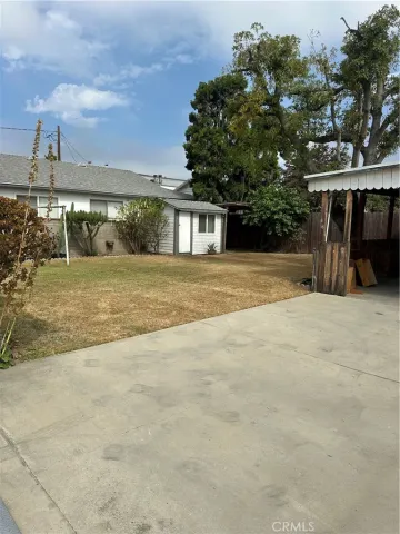 a view of a big building with big yard and large trees