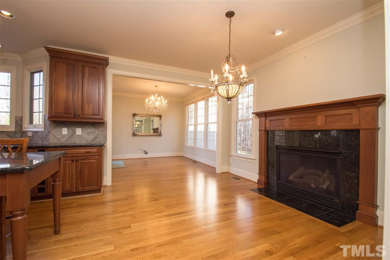 1068 Tacketts Pond Drive Raleigh, NC 27614 - Photo 14 of 25 Amazing gourmet kitchen with large center island, granite counters, stainless steel appliances, tons of cabinet and counter space. Also enjoy the perfect breakfast area with fireplace and cozy keeping room Breakfast Area