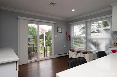 a bedroom with a bed and large windows