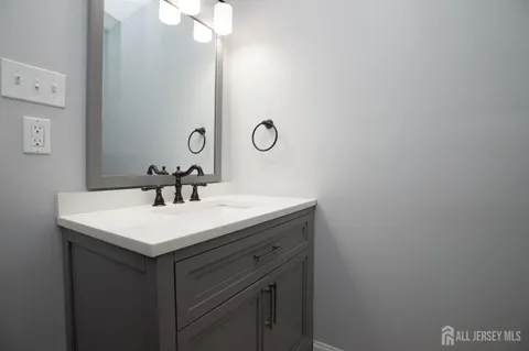 a bathroom with a sink vanity and a mirror