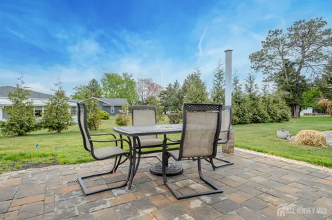 a view of a table and chairs in the garden