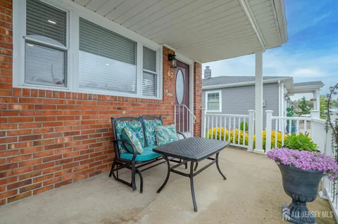 a balcony with furniture and a potted plant