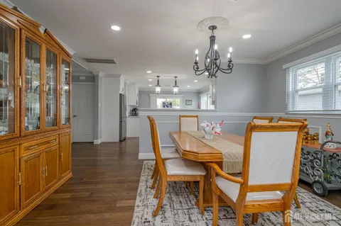 a view of a dining room with furniture and a chandelier