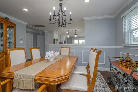 a living room with dining table and chairs