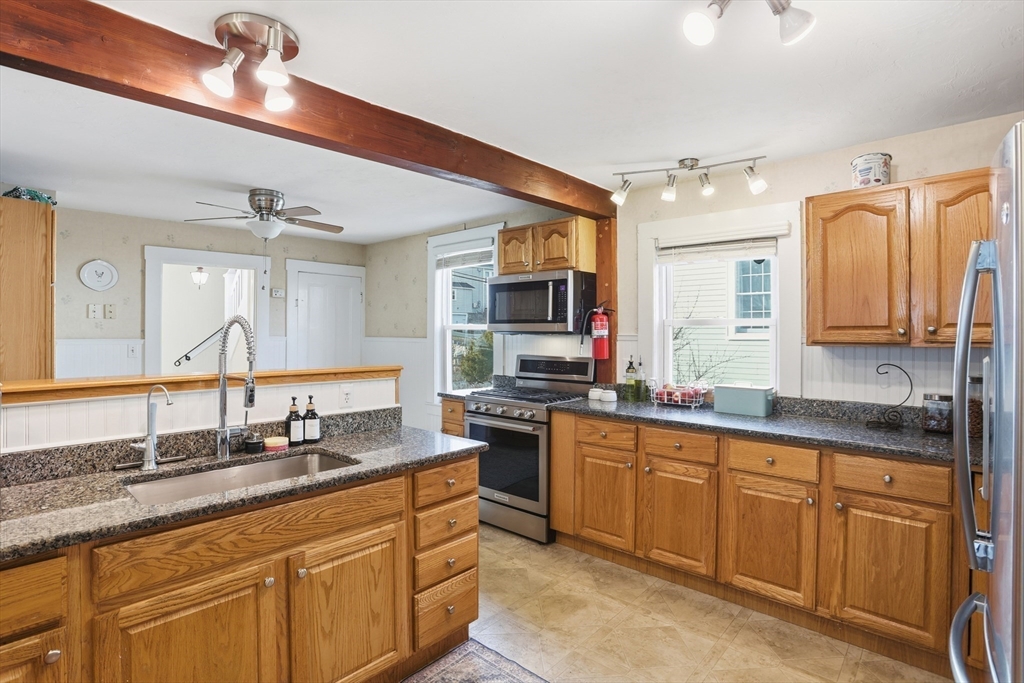8 Perham Street Chelmsford, MA 01824 - Photo 12 of 28 a large kitchen with granite countertop a sink stainless steel appliances and cabinets