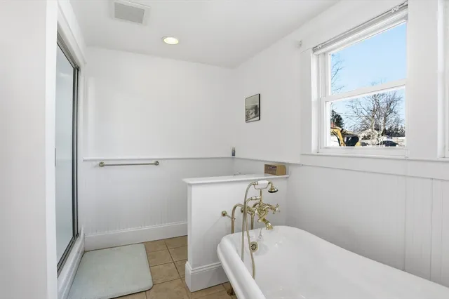 a bedroom with a bed window and a couch