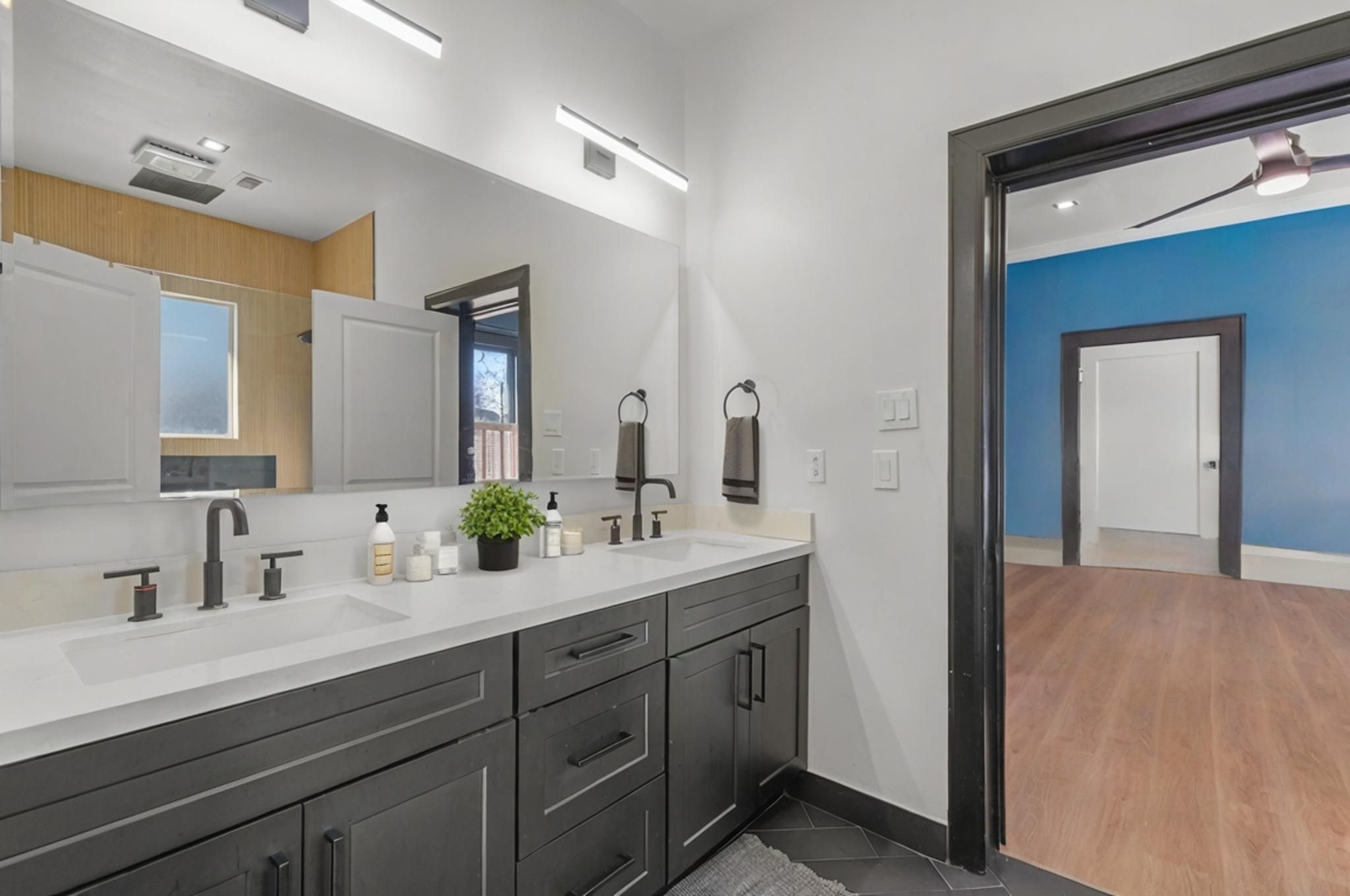 943 Pecore Street Houston, TX 77009 - Photo 9 of 19 Super sleek and modern bathroom with double sinks, LED light fixtures, and walk-in shower.