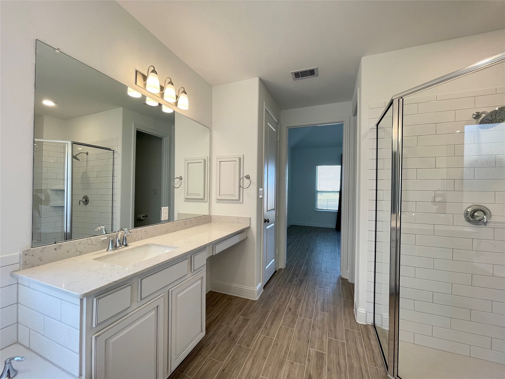 29806 Cherry Vine Road Katy, TX 77494 - Photo 14 of 30 a spacious bathroom with a double vanity sink and a mirror