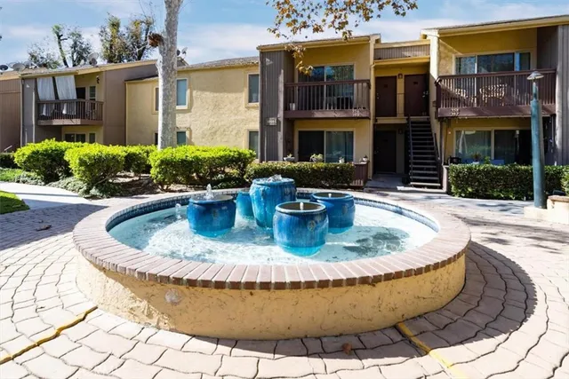 a view of a house with swimming pool and a yard