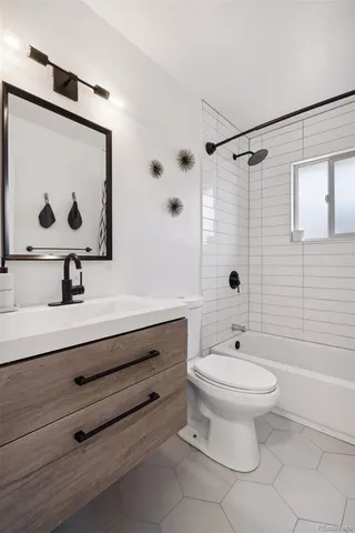 a bathroom with a sink toilet a mirror and shower