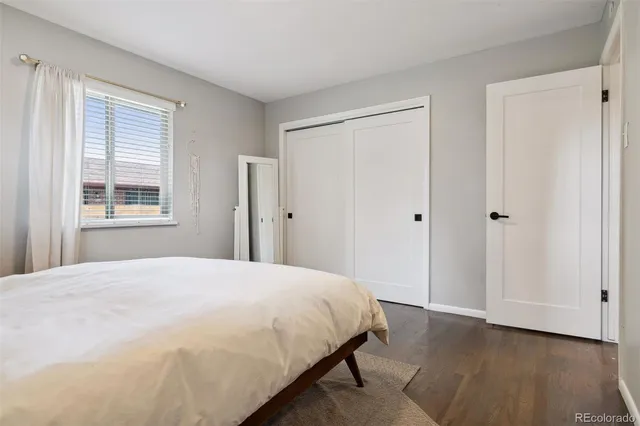 a bedroom with a bed cabinet and a window