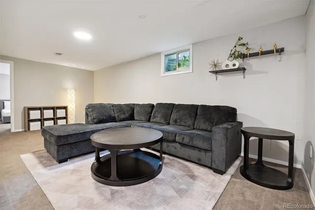 a living room with furniture a rug and a table