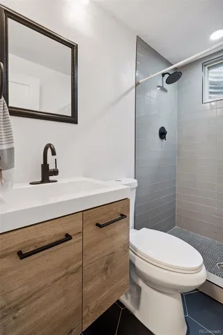 a bathroom with a shower curtain and a toilet