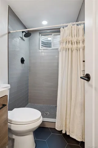 a bedroom with a bed and paintings on the wall