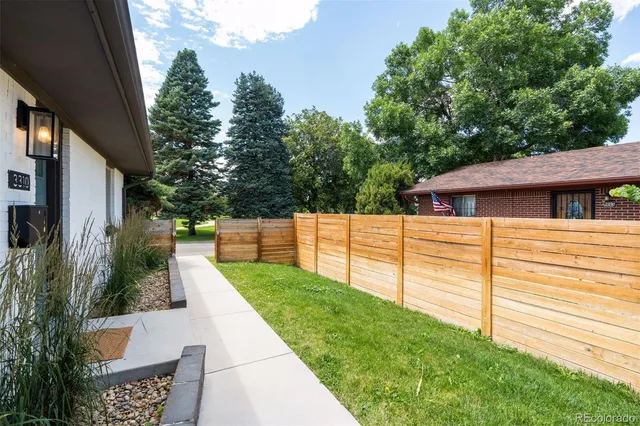 a backyard of a house with wooden floor and fence