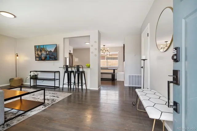 a view of a livingroom with furniture and a floor to ceiling window