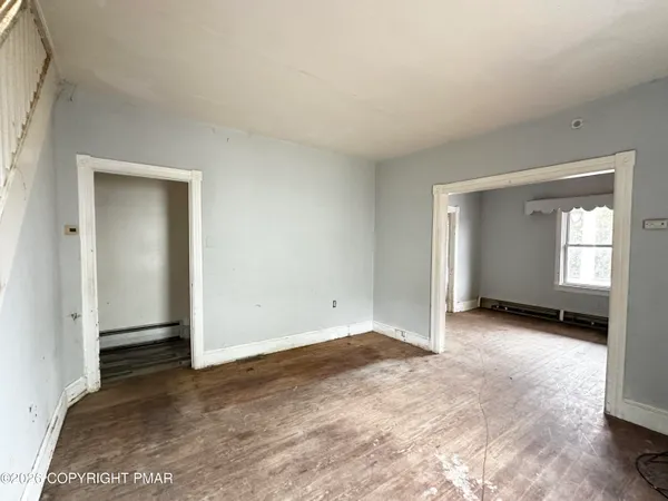 a kitchen with stainless steel appliances a stove top oven a refrigerator cabinets and wooden floor