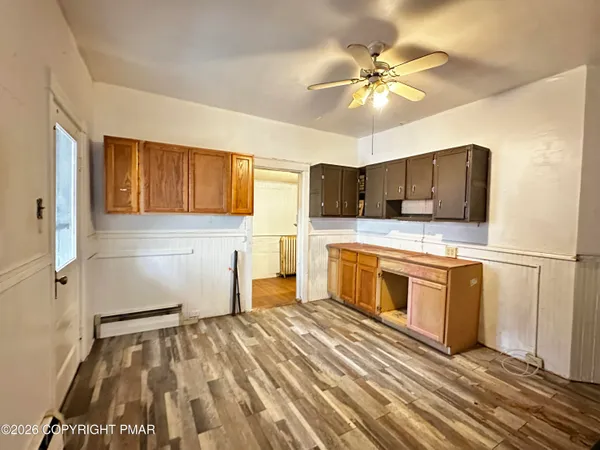 a kitchen with stainless steel appliances kitchen island granite countertop a refrigerator and a stove top oven