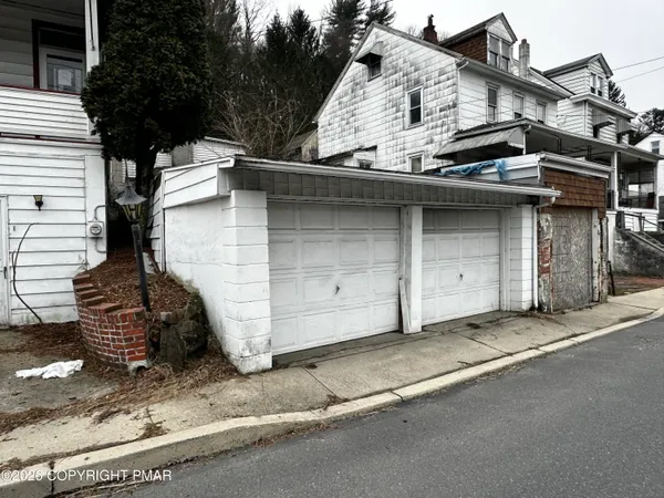 a view of a brick house with large windows