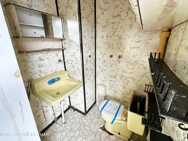 an empty room with windows and door