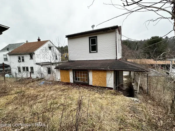 a backyard of a house with table and chairs