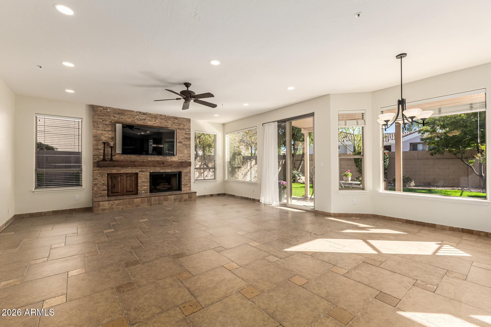 9719 East Pine Valley Road Scottsdale, AZ 85260 - Photo 11 of 62 a view of an empty room with a fireplace and a window