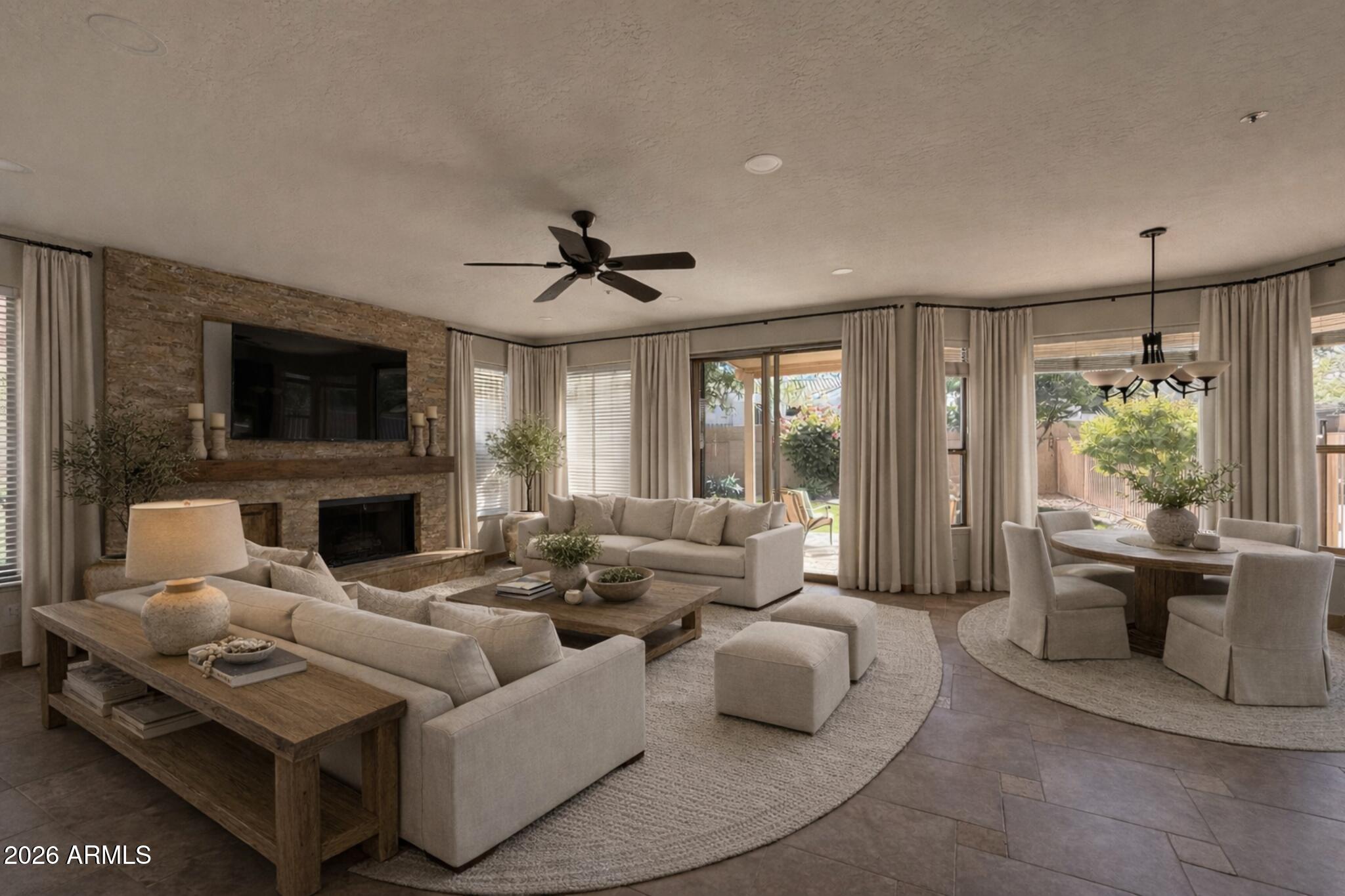9719 East Pine Valley Road Scottsdale, AZ 85260 - Photo 12 of 62 a living room with furniture a fireplace and a flat screen tv