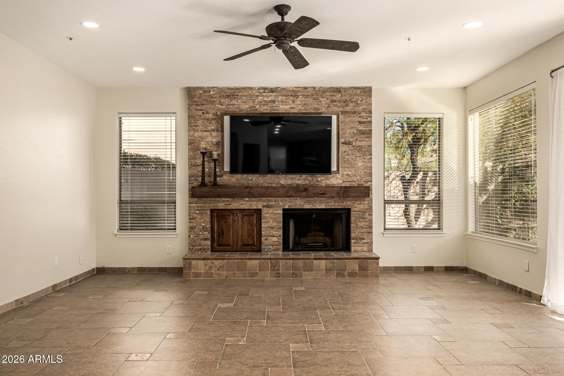 9719 East Pine Valley Road Scottsdale, AZ 85260 - Photo 13 of 62 a view of an empty room with a fireplace and a window
