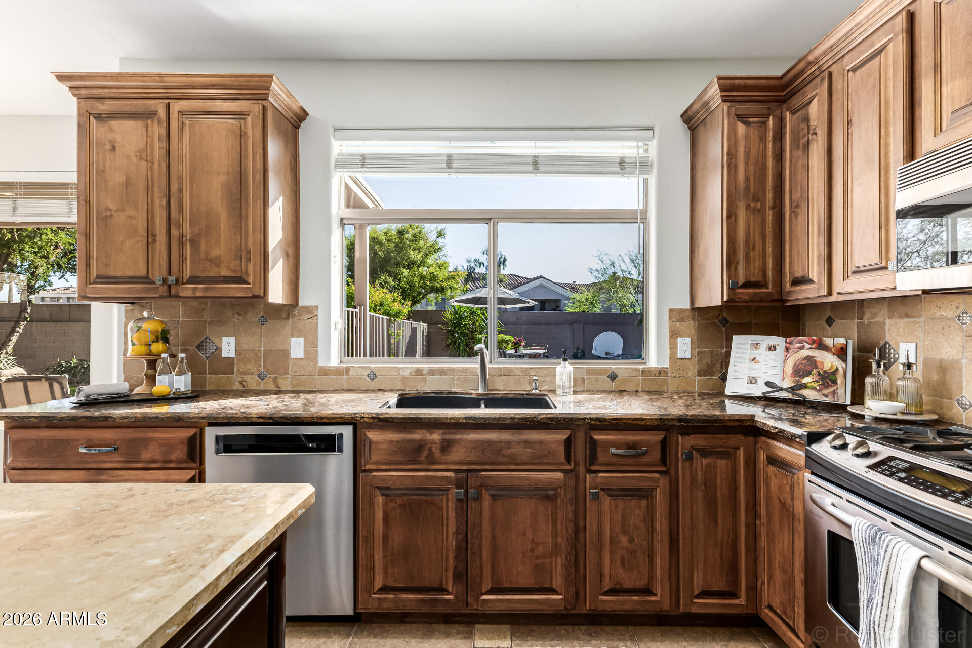 9719 East Pine Valley Road Scottsdale, AZ 85260 - Photo 17 of 62 a kitchen with stainless steel appliances granite countertop a stove a sink and a microwave