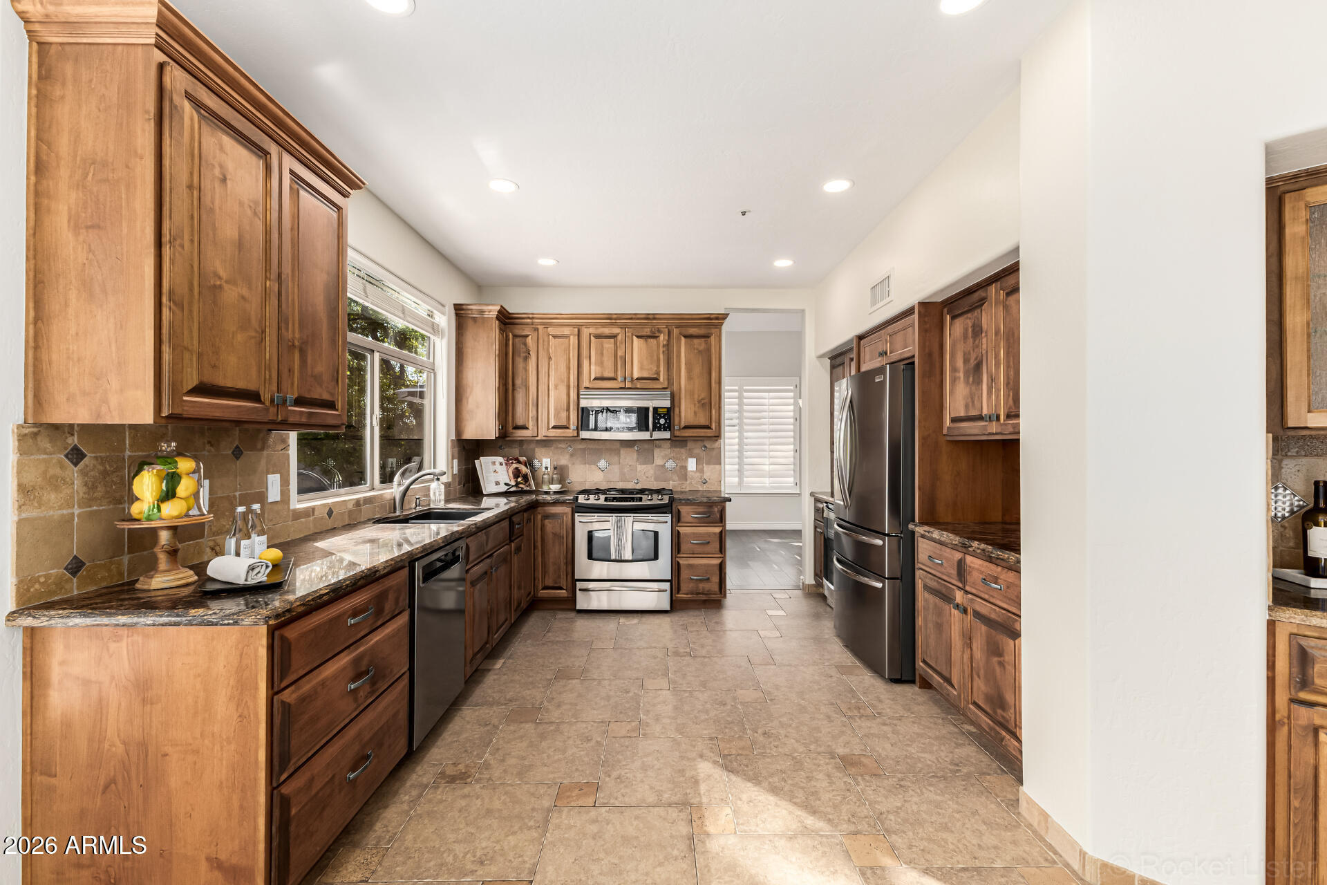 9719 East Pine Valley Road Scottsdale, AZ 85260 - Photo 22 of 62 a kitchen with stainless steel appliances granite countertop a refrigerator and a stove top oven