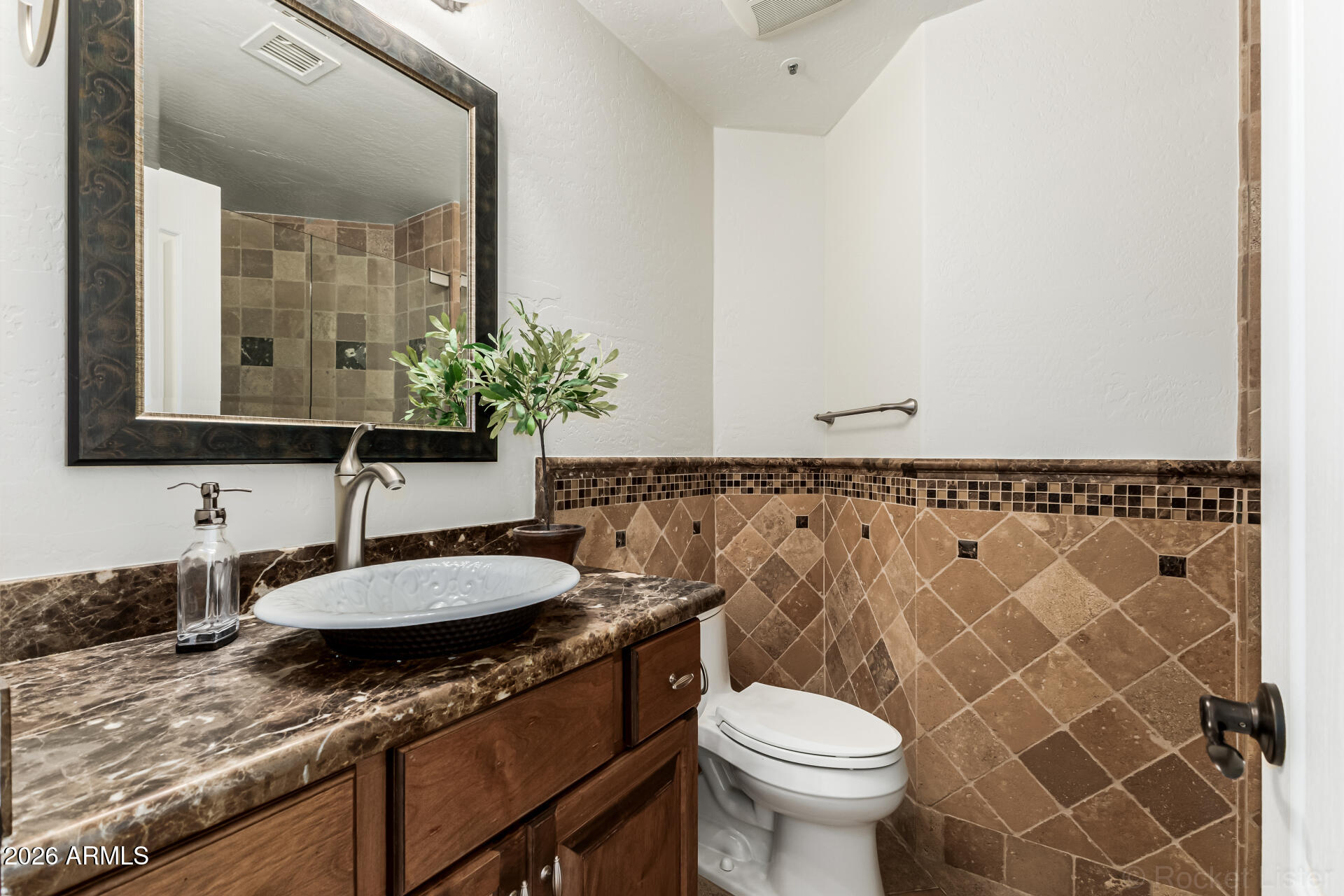 9719 East Pine Valley Road Scottsdale, AZ 85260 - Photo 25 of 62 a bathroom with a granite countertop toilet sink and mirror