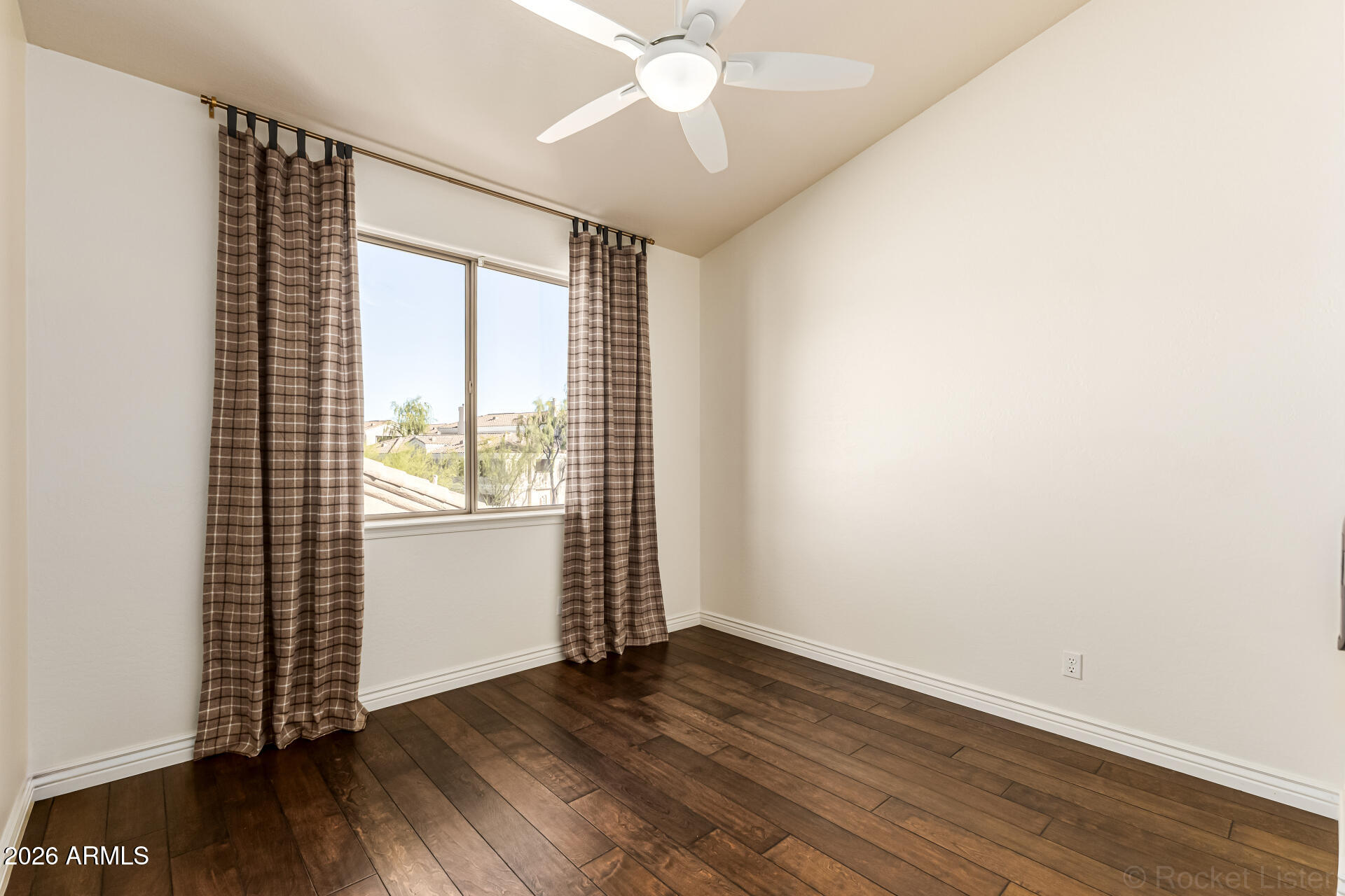 9719 East Pine Valley Road Scottsdale, AZ 85260 - Photo 41 of 62 an empty room with wooden floor and windows