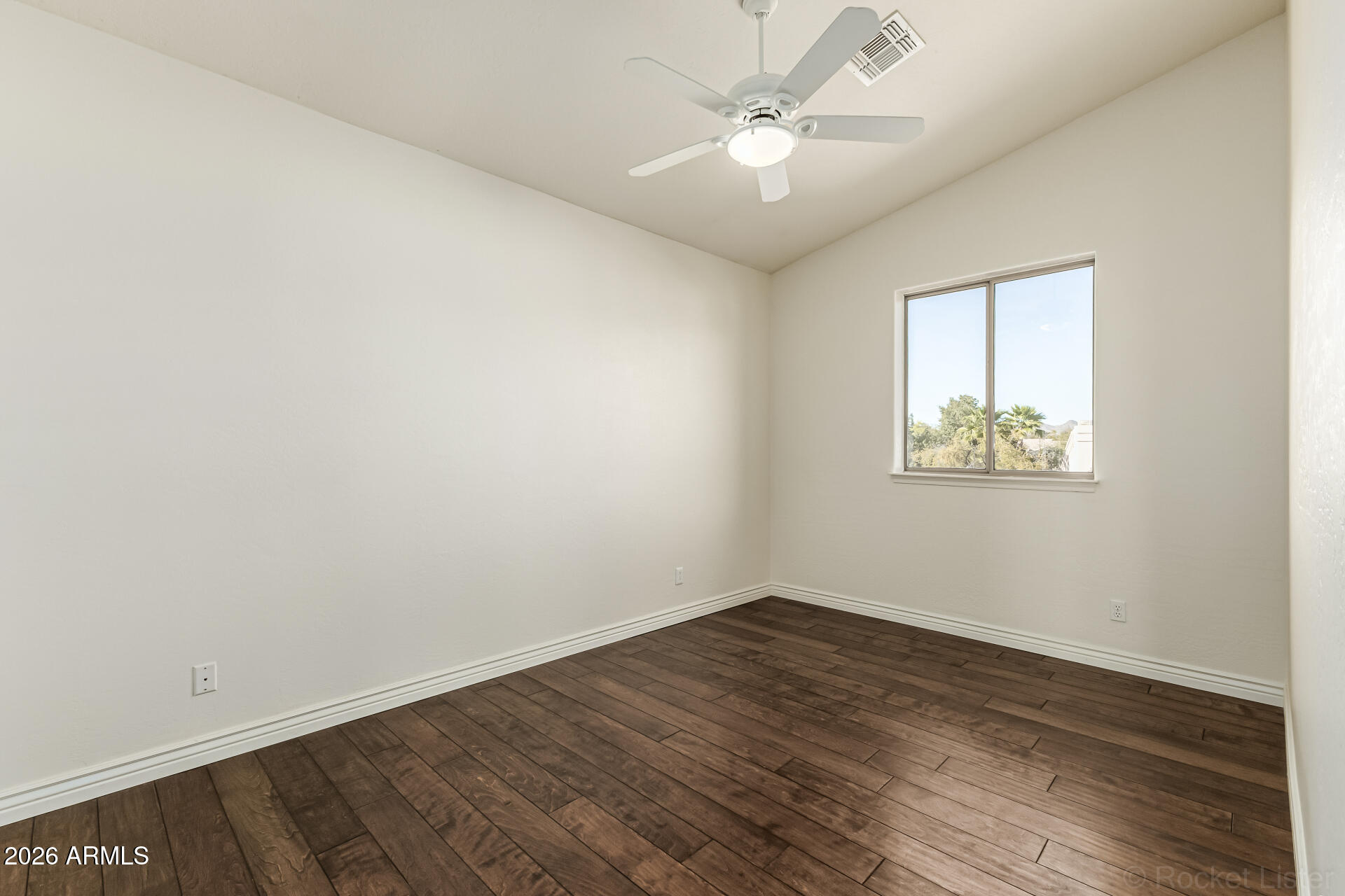 9719 East Pine Valley Road Scottsdale, AZ 85260 - Photo 45 of 62 an empty room with wooden floor and window