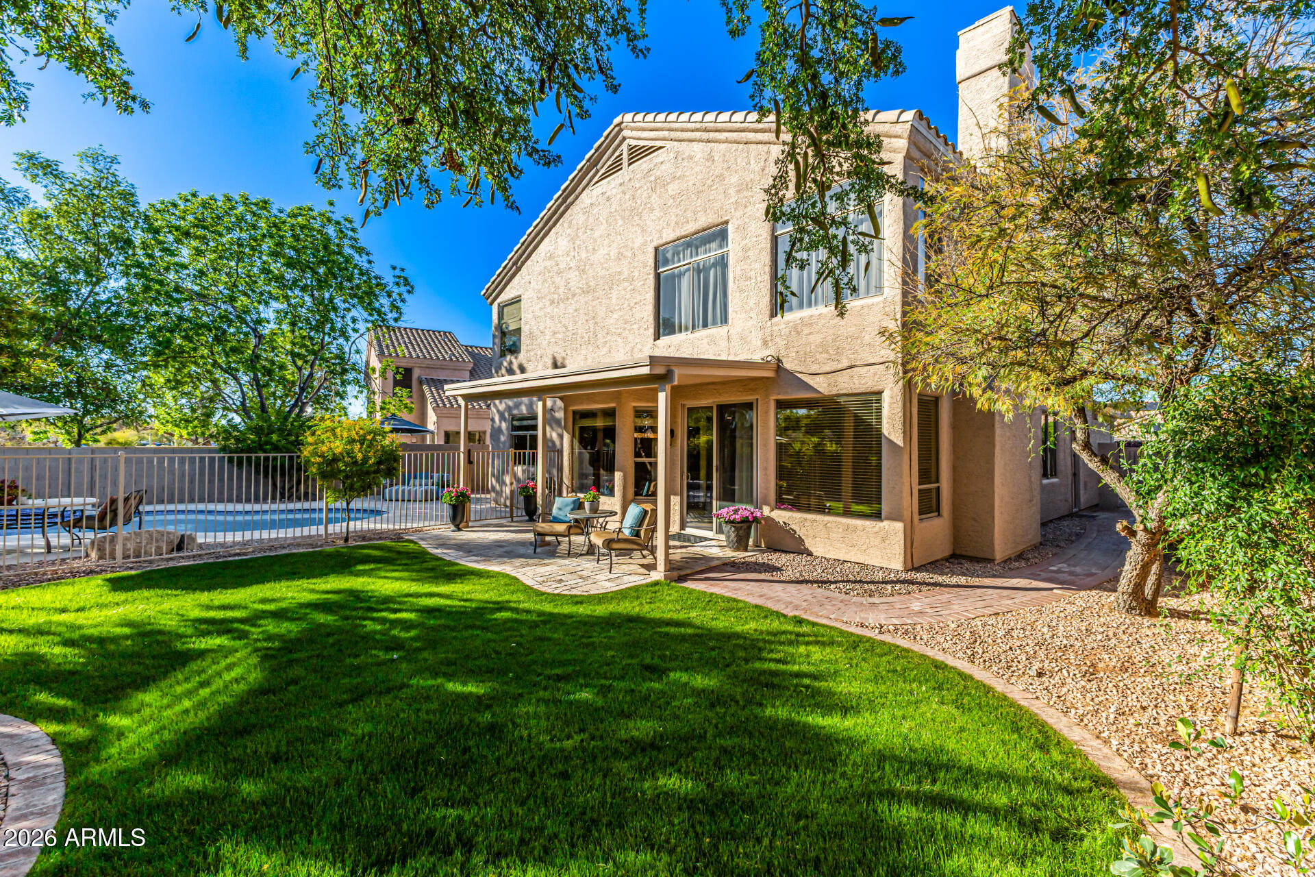 9719 East Pine Valley Road Scottsdale, AZ 85260 - Photo 55 of 62 a view of a house with a yard and sitting area