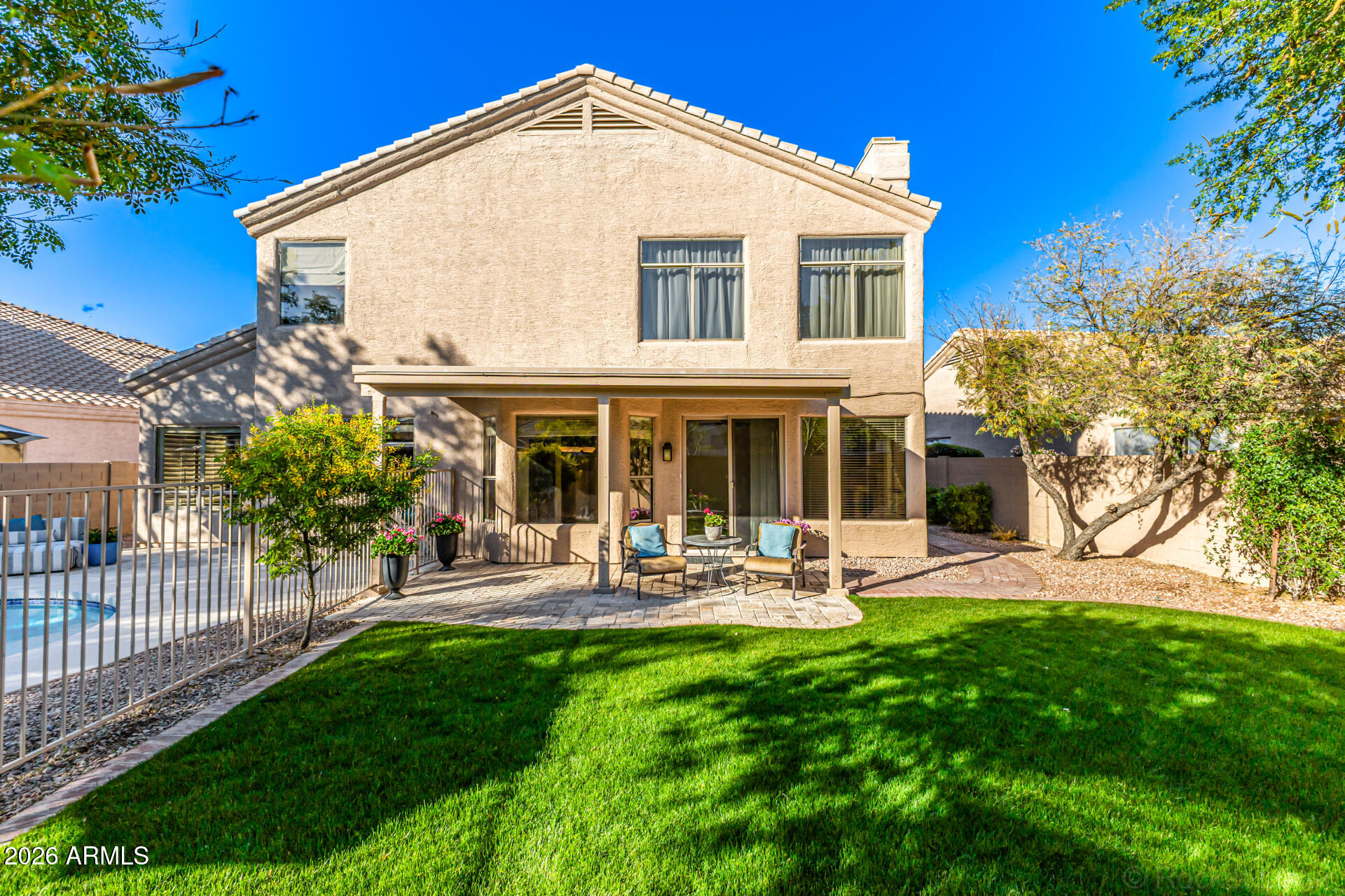 9719 East Pine Valley Road Scottsdale, AZ 85260 - Photo 57 of 62 a front view of a house with garden and porch