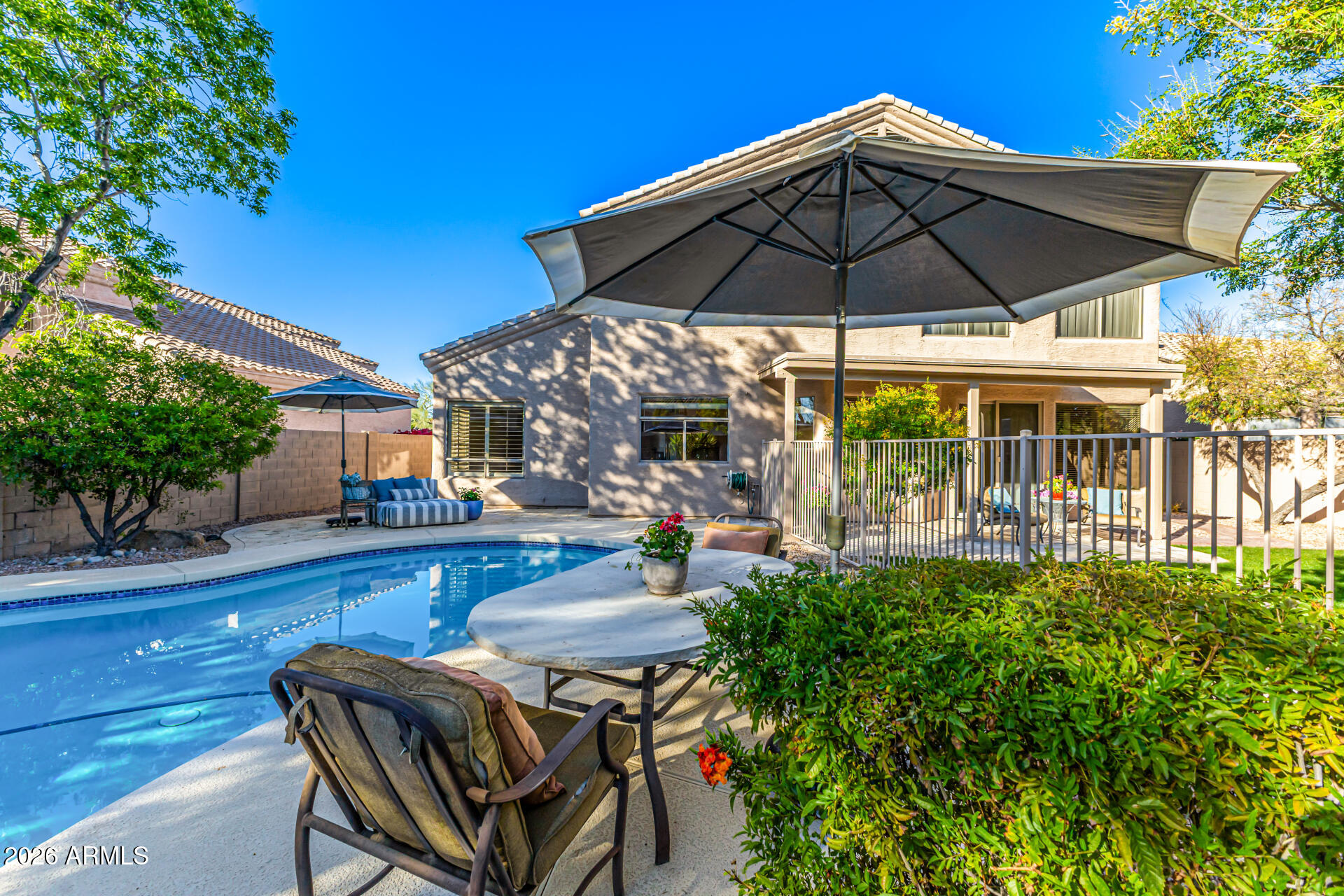9719 East Pine Valley Road Scottsdale, AZ 85260 - Photo 59 of 62 a view of patio with chairs and table under an umbrella