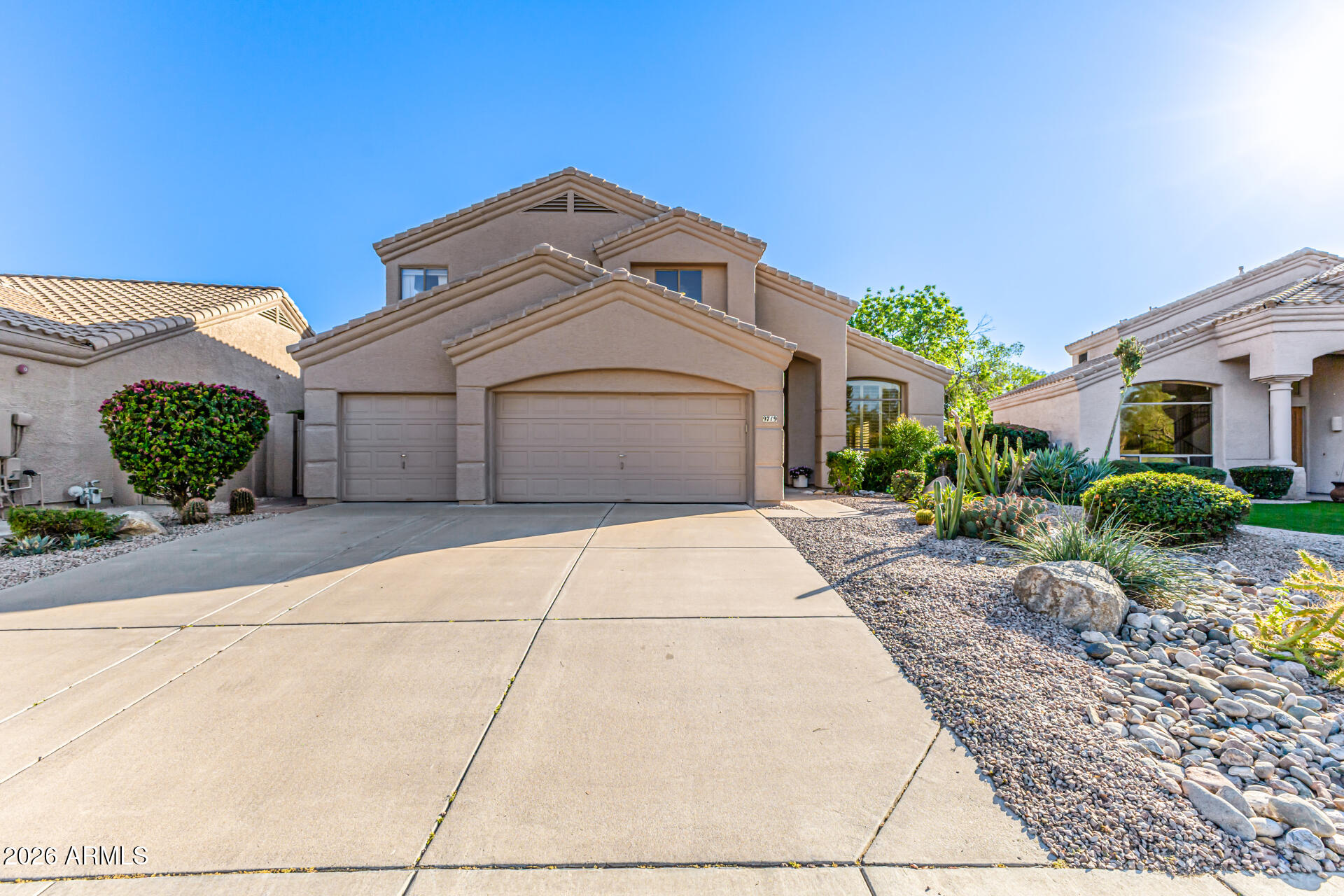 9719 East Pine Valley Road Scottsdale, AZ 85260 - Photo 61 of 62 a front view of a house with garden